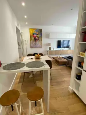 a kitchen and living room with a table and chairs at Maison de charme Domus Clodio XIV in Rome