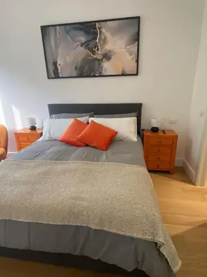 a bedroom with a bed with orange pillows on it at Maison de charme Domus Clodio XIV in Rome