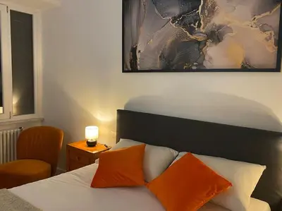 a bedroom with a bed with two orange pillows at Maison de charme Domus Clodio XIV in Rome