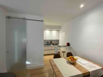a kitchen with a table with a bowl of fruit on it at Maison de charme Domus Clodio XIV in Rome