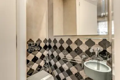 a bathroom with a sink and a toilet at Ibernesi Luxury Home in Rome
