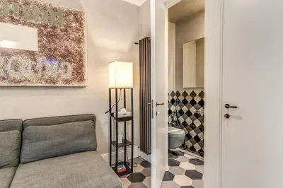 a living room with a couch and a toilet at Ibernesi Luxury Home in Rome