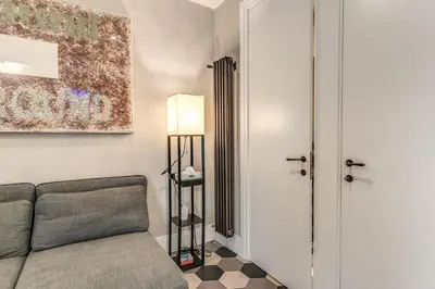 a living room with a couch and a lamp at Ibernesi Luxury Home in Rome