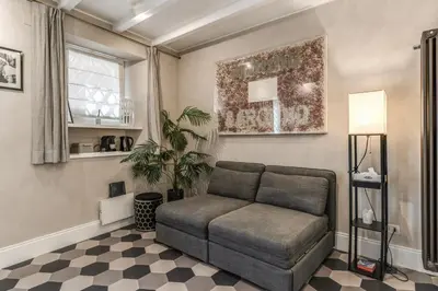 a couch in a living room with a checkered floor at Ibernesi Luxury Home in Rome