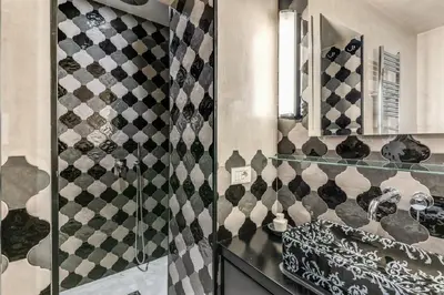 a bathroom with a shower with a sink and a mirror at Ibernesi Luxury Home in Rome