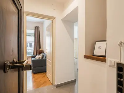 an open door to a living room with a couch at The Best Rent - Two-bedroom apartment in Colosseum area in Rome