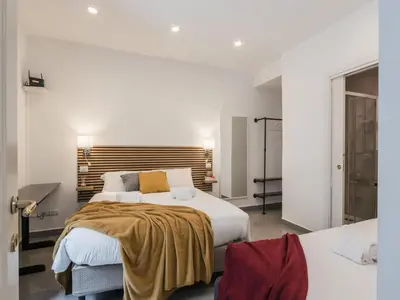 a bedroom with a large bed with a wooden headboard at The Best Rent - Two-bedroom apartment in Colosseum area in Rome