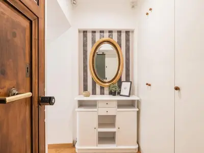 a hallway with a mirror and a white cabinet at The Best Rent - Spacious three-bedroom apartment near the Colosseum in Rome