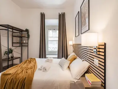 a bedroom with a bed with two towels on it at The Best Rent - Spacious three-bedroom apartment near the Colosseum in Rome