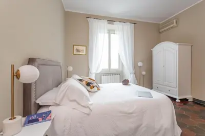 a bedroom with a white bed and a window at Daplace - Beatrice Apartment in Rome
