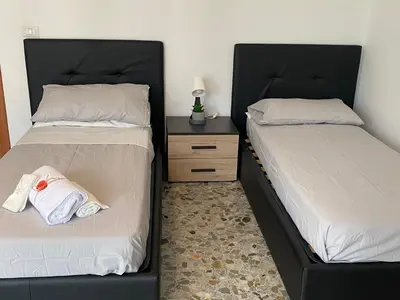 two beds sitting next to each other in a bedroom at Pisana 247 St Peter in Rome