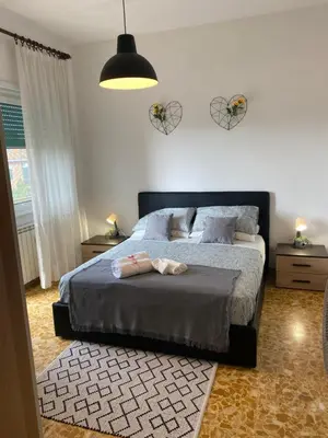 a bedroom with a bed with two shoes on it at Pisana 247 St Peter in Rome