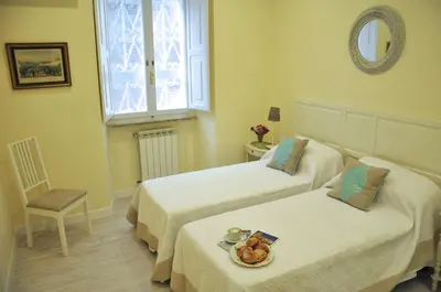 a room with two beds with a plate of food on them at The Avalon in Rome
