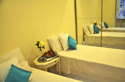 a hotel room with two beds and a mirror at The Avalon in Rome