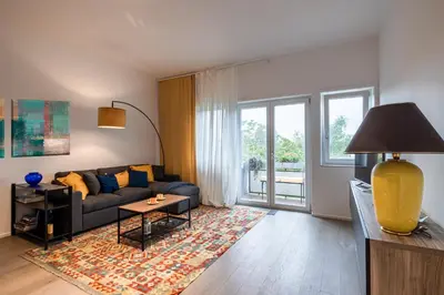 a living room with a couch and a large window at Suite close to Vatican City - Ingresso Spa in Rome