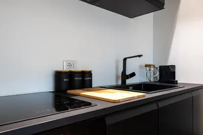 a kitchen with a sink and a counter top at Suite close to Vatican City - Ingresso Spa in Rome