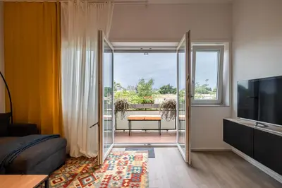 a living room with a sliding glass door to a balcony at Suite close to Vatican City - Ingresso Spa in Rome