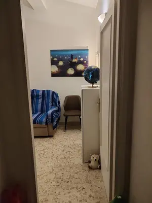 a hallway with a desk and a chair in a room at Flat on Roman Rooftop in Rome