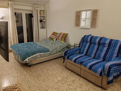 a bedroom with a bed and a couch at Flat on Roman Rooftop in Rome