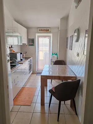 a kitchen with a table and chairs in a room at Flat on Roman Rooftop in Rome