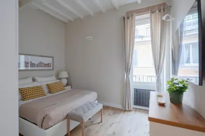 a white bedroom with a bed and a window at THE BREAK - Piazza di Spagna Maison Deluxe Terrace in Rome