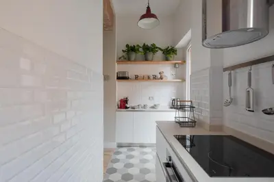 a white kitchen with a sink and a counter at THE BREAK - Piazza di Spagna Maison Deluxe Terrace in Rome