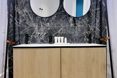 a bathroom with a vanity with two mirrors at Youroom Quattro Fontane - Rooms in Rome