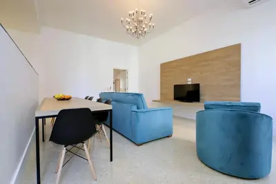 a dining room with blue chairs and a table at Youroom Quattro Fontane - Rooms in Rome