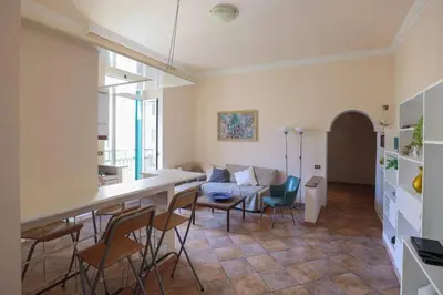 a kitchen and living room with a couch and chairs at La Dolce Vita - IRIDE's Nest in Rome