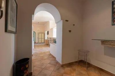 a hallway with an archway in a home with a kitchen at La Dolce Vita - IRIDE's Nest in Rome