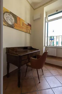 a piano in a room with a chair and a window at La Dolce Vita - IRIDE's Nest in Rome