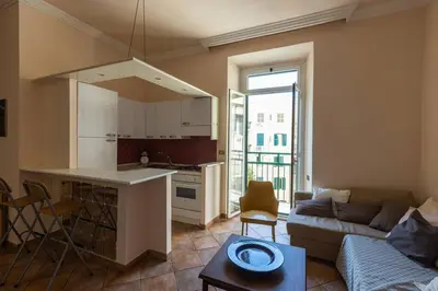 a kitchen and living room with a couch and a table at La Dolce Vita - IRIDE's Nest in Rome
