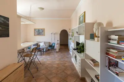 a kitchen and living room with a table and chairs at La Dolce Vita - IRIDE's Nest in Rome