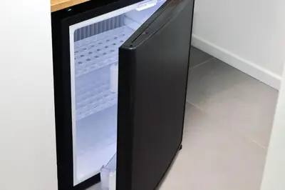 a refrigerator with its door open in a room at YCH-Montebello - Rooms in Rome