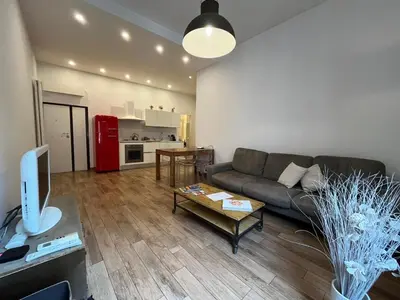 a living room with a couch and a table at La Dolce Vita - Luxury Colosseum Boutique Apartment in Rome