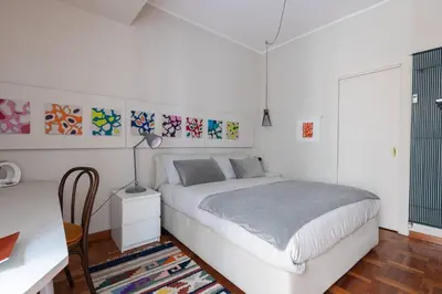 a white bedroom with a bed and a desk at La Dolce Vita - Old Testaccio Authentic District in Rome