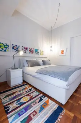 a white bedroom with a bed and a rug at La Dolce Vita - Old Testaccio Authentic District in Rome