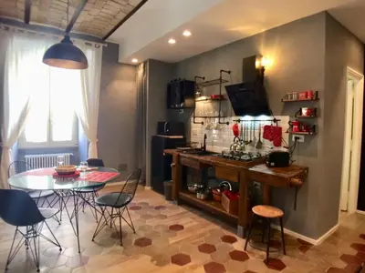 a kitchen and dining room with a table and chairs at Roma Testaccio - Volta 45 apartment in Rome