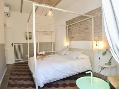 a bedroom with a white canopy bed and two tables at Roma Testaccio - Volta 45 apartment in Rome
