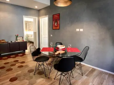 a dining room with a glass table and chairs at Roma Testaccio - Volta 45 apartment in Rome
