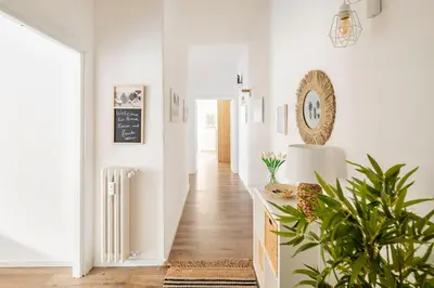 a hallway with white walls and a plant at tibershome home la casa sul tevere in Rome