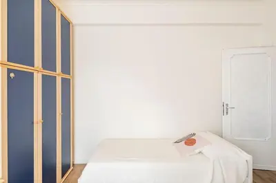 a bedroom with a white bed and a window at tibershome home la casa sul tevere in Rome