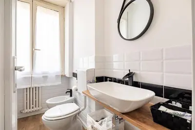 a bathroom with a white toilet and a mirror at tibershome home la casa sul tevere in Rome