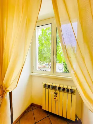 a room with a window and a radiator in front of it at Giardino degli Aranci Lulus Home in Rome