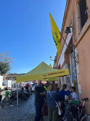 a group of people standing under a yellow tent at Shabby Roman Studio- ai fori Imperiali in Rome