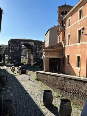 a city street with a bridge and some buildings at Shabby Roman Studio- ai fori Imperiali in Rome