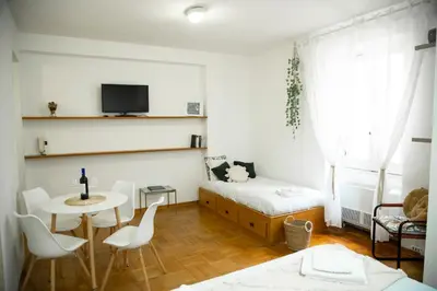 a small room with a bed and a table and chairs at Shabby Roman Studio- ai fori Imperiali in Rome