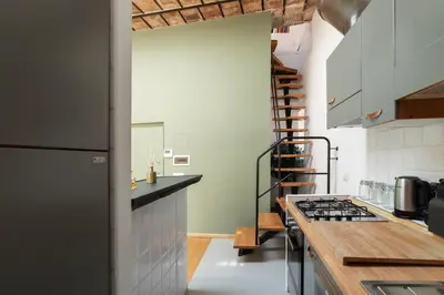 a kitchen with a counter and a stove top oven at GuestHost - Cancelleria Rooftop Garden in Rome