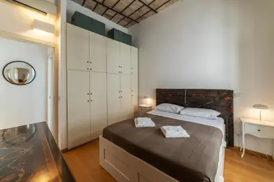 a bedroom with a bed and a dresser and a bed sidx sidx sidx sidx at GuestHost - Cancelleria Rooftop Garden in Rome
