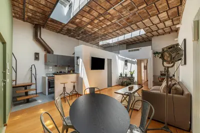 a large living room with a table and chairs at GuestHost - Cancelleria Rooftop Garden in Rome